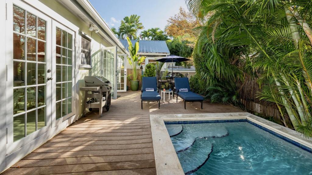 a house with a swimming pool next to a house at Dos Casitas by Last Key Realty in Key West