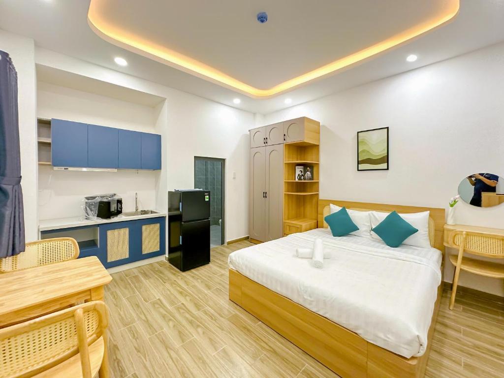 a large room with a bed and a kitchen at Urbanest Saigon in Ho Chi Minh City