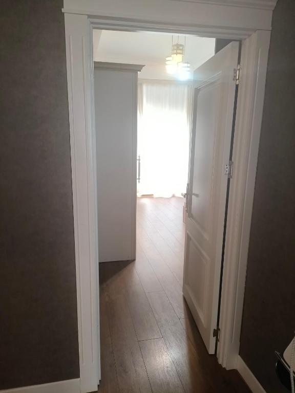 a door to a room with a window and a hallway at Home away home in Mekhrably