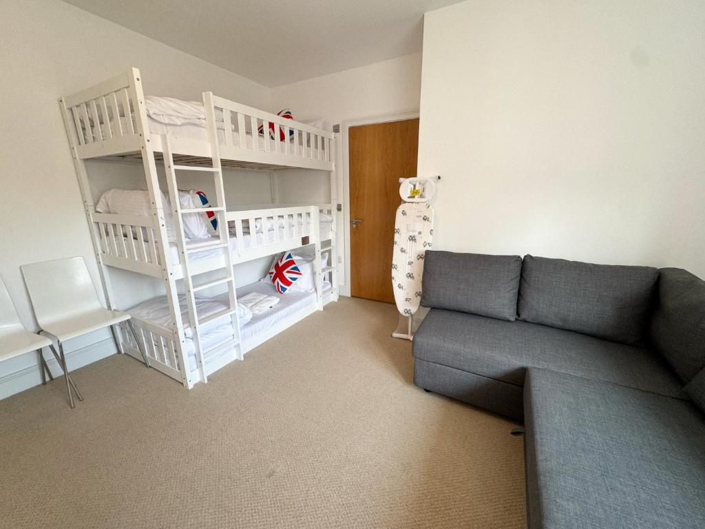 a living room with a couch and a bunk bed at Penthouse on the Grange in London