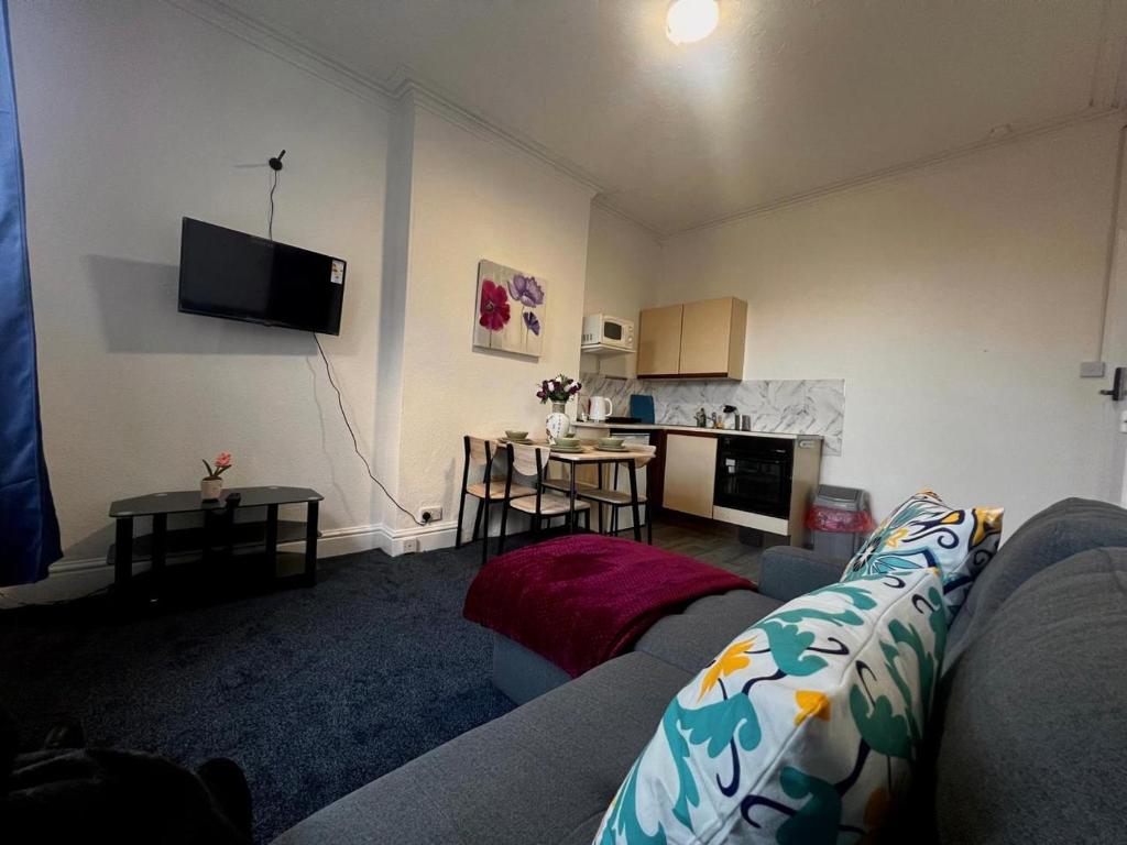 a living room with a couch and a table at Cozy one bedroom flat sleeps 5 Skegness F6 in Skegness