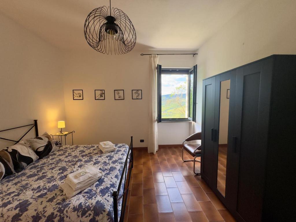 a bedroom with a bed and a window at Casita in Radda in Chianti