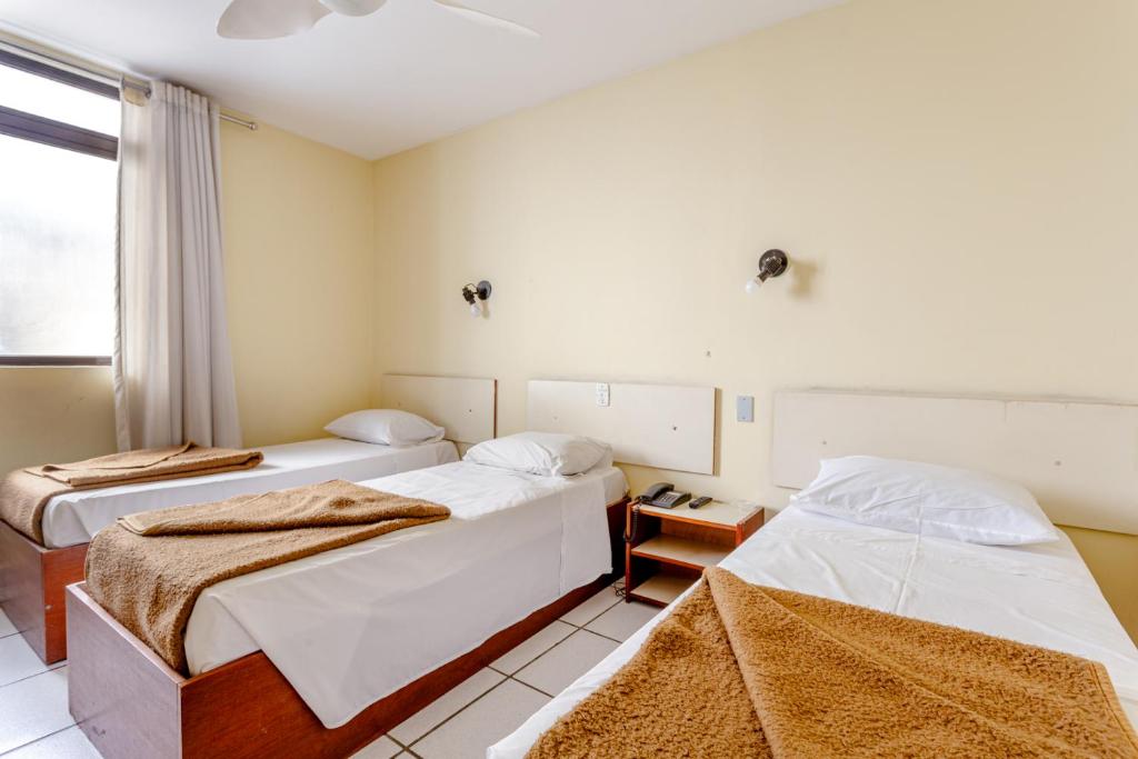 Una cama o camas en una habitación de Daher Center Hotel