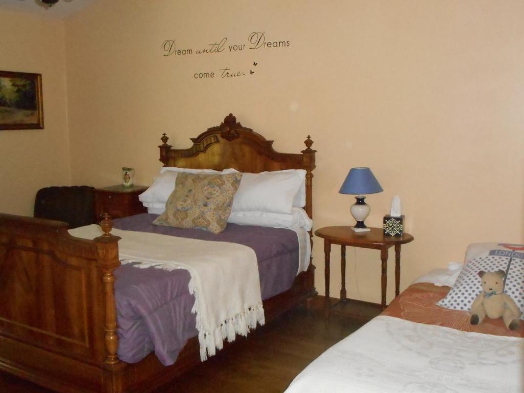 a bedroom with two beds and a sign on the wall at Chambres d'hôtes Le Forgeron in Châteaumur