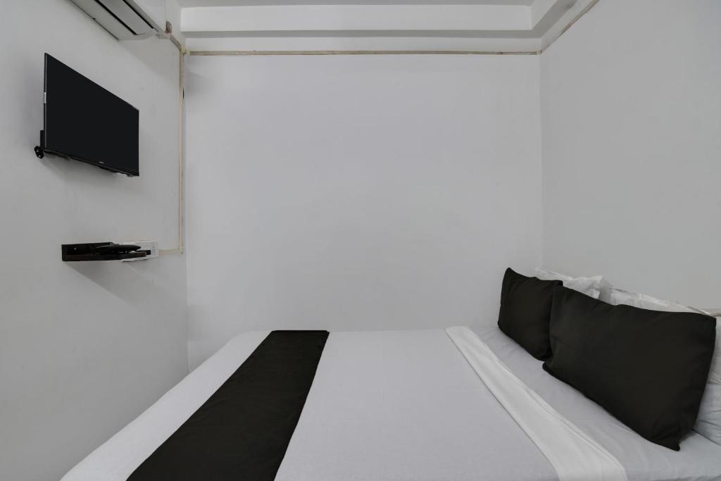 Postel nebo postele na pokoji v ubytování Hotel O PPS NEST Guest House