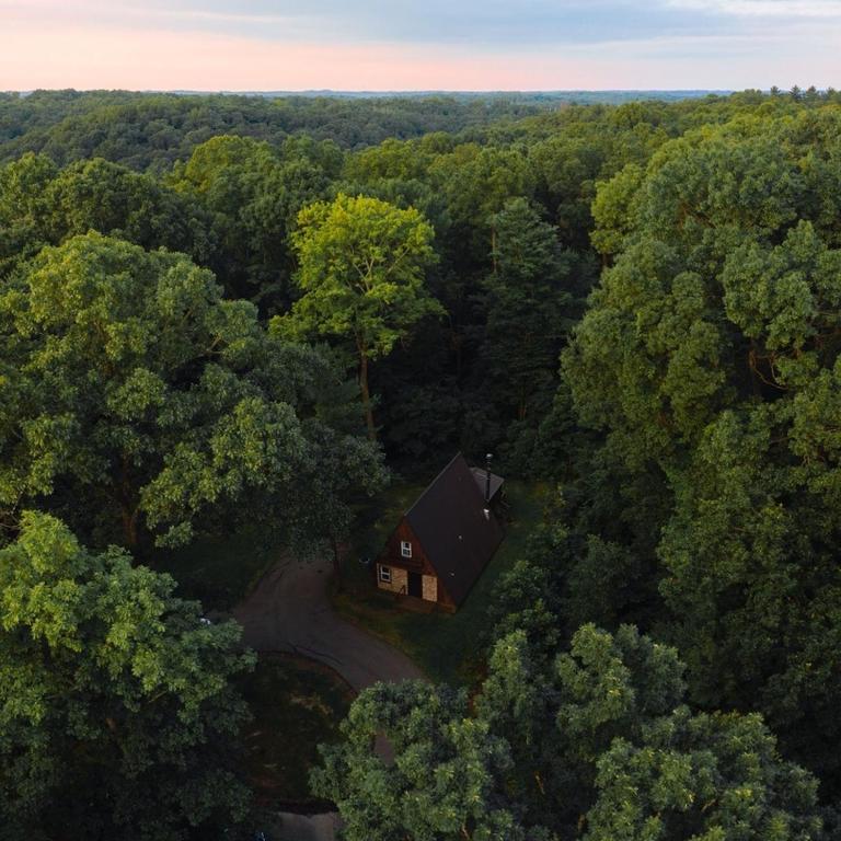 an overhead view of a house in the middle of a forest at A-Frame #01 - by The Chalets in Logan