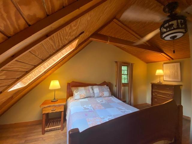 a bedroom with a large bed in a attic at Pioneer - by The Chalets in South Bloomingville
