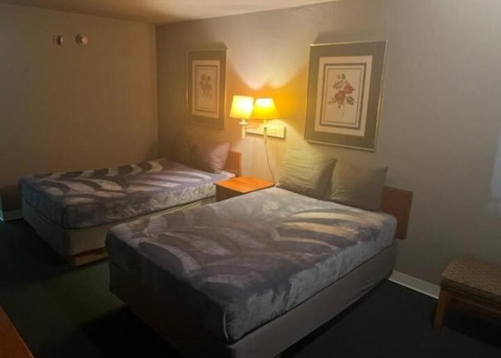 a hotel room with two beds and a lamp at 2 Double Beds Hotel Studio 135 in Livingston
