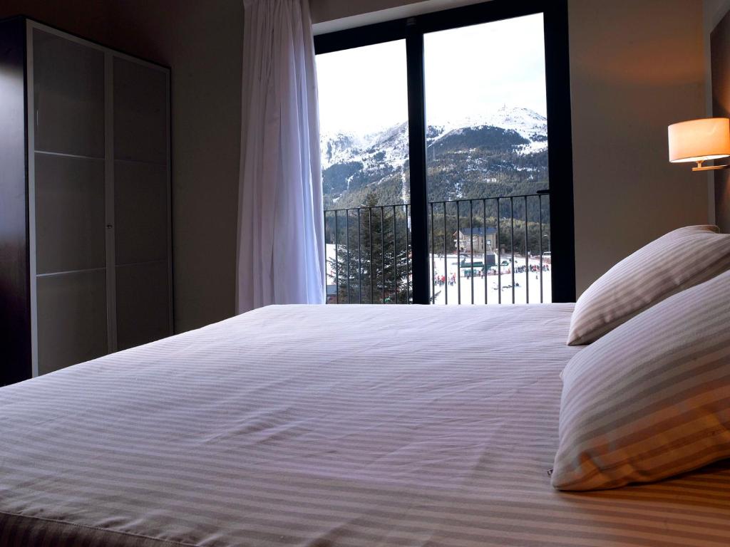 Postel nebo postele na pokoji v ubytování HG La Molina