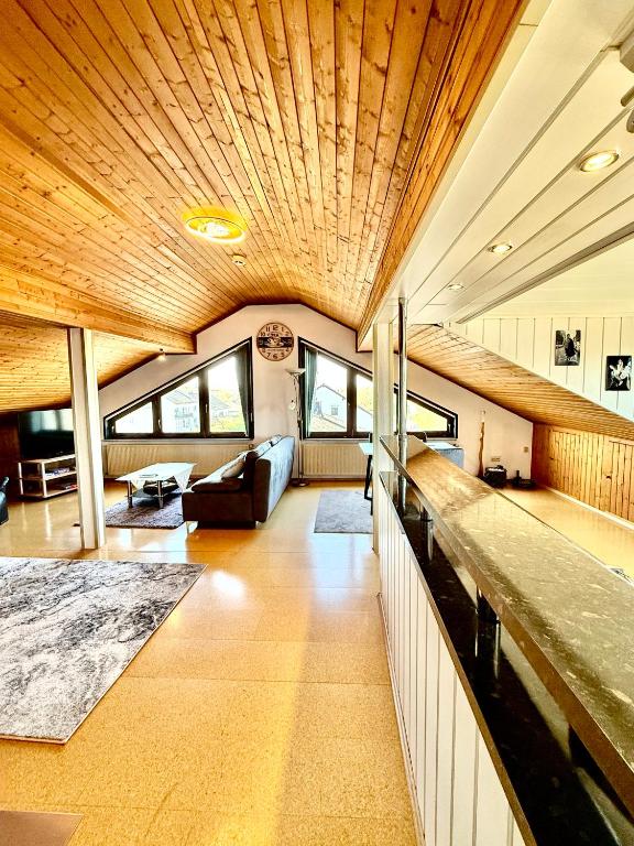 a large living room with a wooden ceiling at Charmante Ferienwohnung Ziegler mit Garten in Villmar