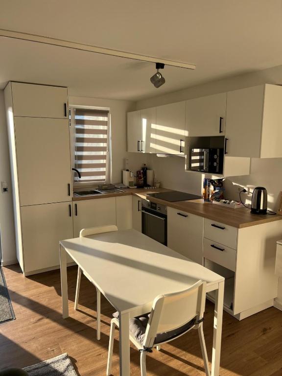 a kitchen with a white table and chairs in it at YourHome 1 in Haigerloch