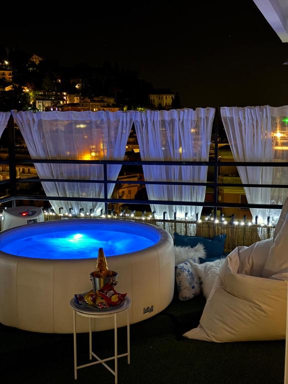 a hot tub on top of a building with lights at Appartamento Rapallo Sky Garden Maria Jose Liguria - Attico vista mare - Terraces - 2 bagni- 2 Camera da Letto - Box, Wi-fi, Idromassaggio Free inteiro Attico per Voi, con Ascensore in Rapallo