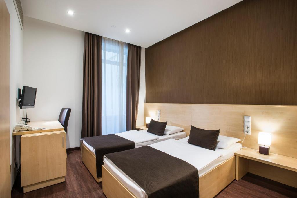 Posteľ alebo postele v izbe v ubytovaní Promenade City Hotel
