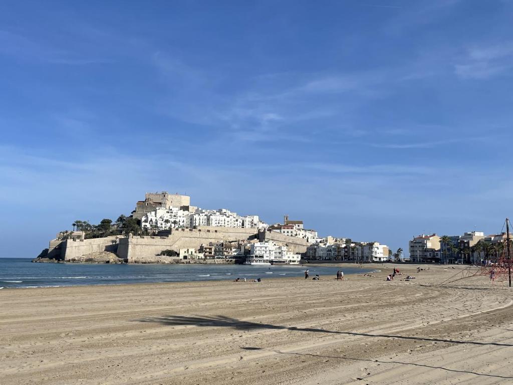a group of people on a beach near the water at Nature Somhome Peñíscola in Peñíscola