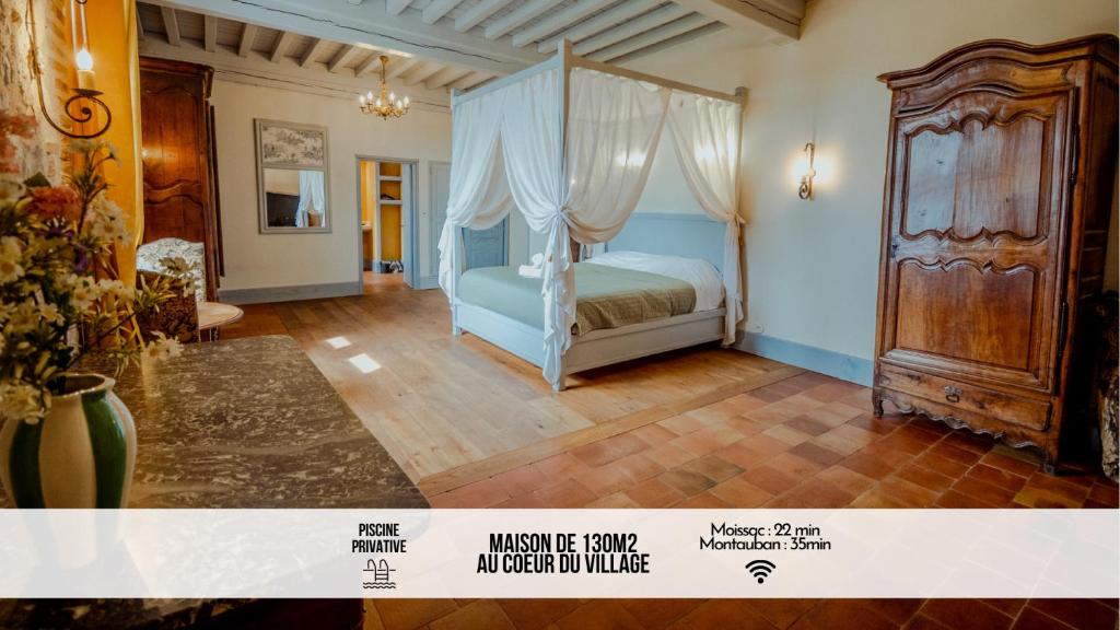a bedroom with a bed with a canopy at La tour de Cadel Maison 130m2 piscine Lauzerte in Lauzerte
