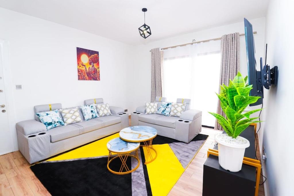 a living room with a couch and a table at Tatu Haven in Tatu City in Tatu City