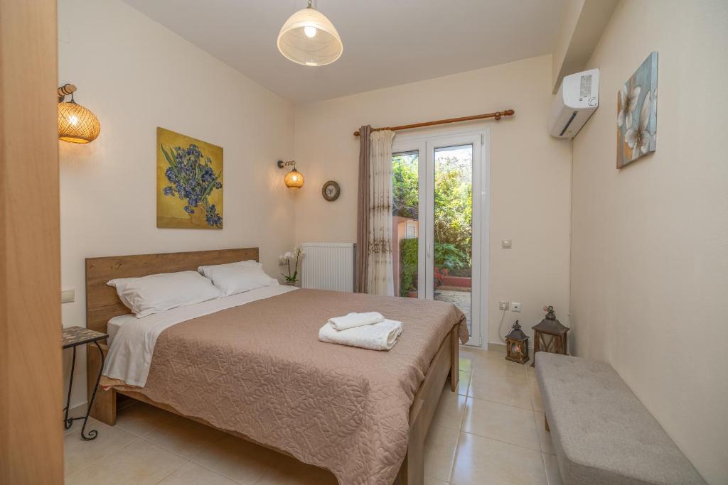 a bedroom with a bed with two towels on it at Estia cozy apartment in Argostoli