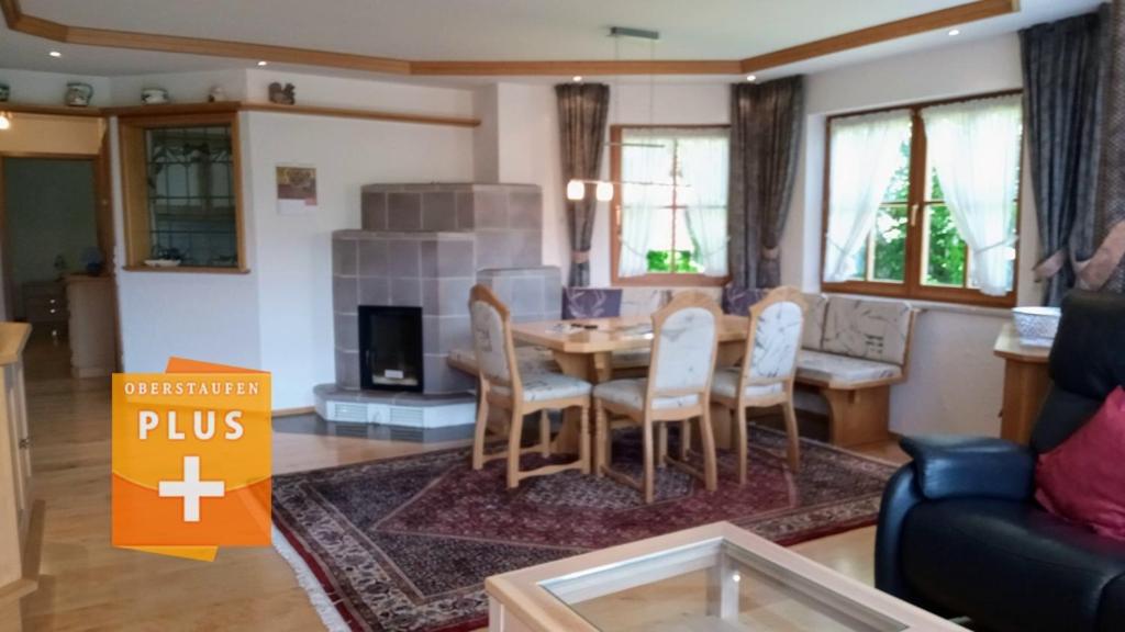 a living room with a table and chairs in a room at "Allgäuglück", Oberstaufen in Oberstaufen