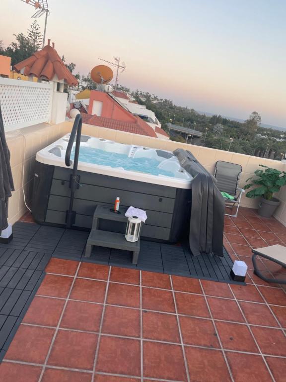 a hot tub on the roof of a house at Basement apartments in San Bartolomé de Tirajana