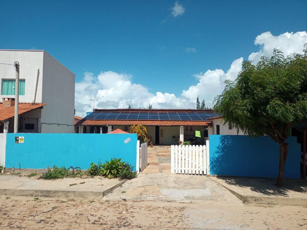 a blue fence in front of a house at Casa de praia in Luis Correia