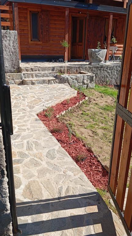 a stone walkway in front of a house at Brvnara Topilo in Niš