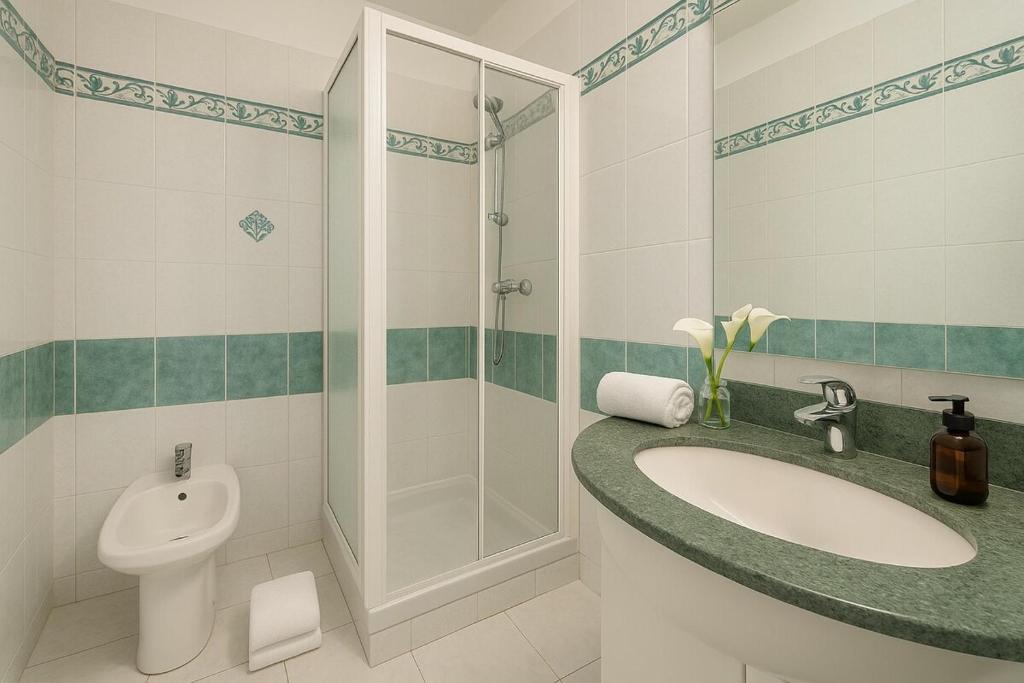 łazienka z umywalką, prysznicem i toaletą w obiekcie Monaco Scala Suite Rickeys w Monte Carlo