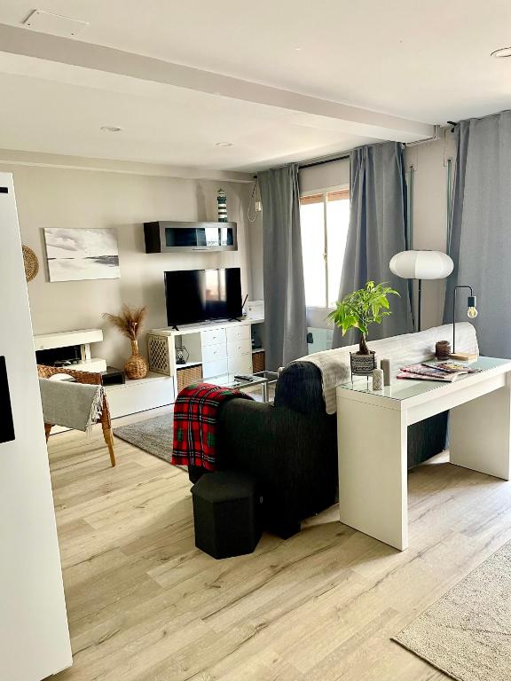a living room with a couch and a table at Alojamiento D'Moda in Ribadeo