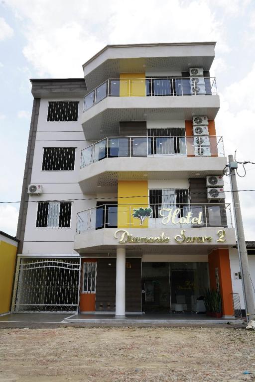 a tall white building with a sign on it at Hotel Diamante Sarare 2 in Saravena