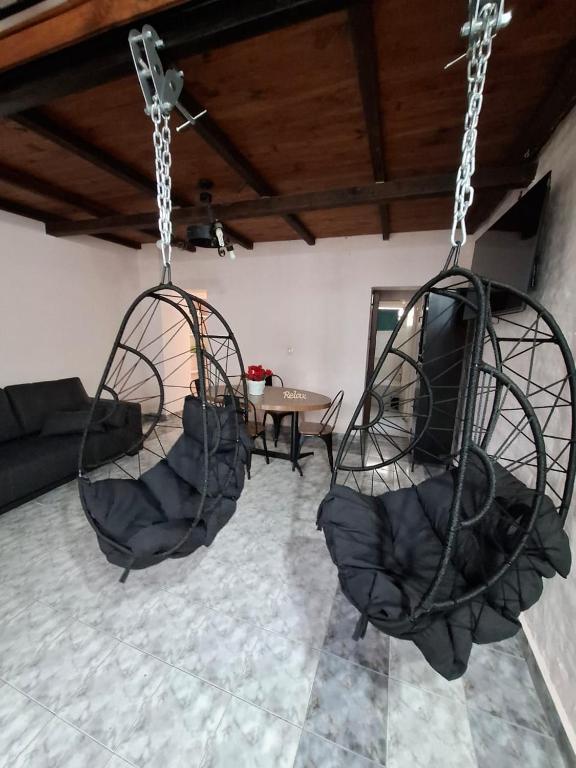 two swings in a living room with a couch at Patagonia Faro Norte Lighthouse in Carmen de Patagones