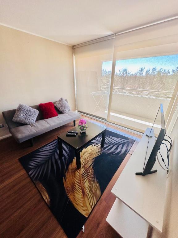 a living room with a couch and a table at Departamento 2 Habitaciones 2 Baños 4 Camas Indivuduales in Calama