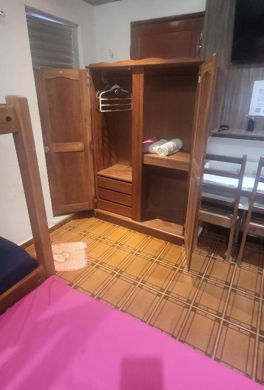 a room with a wooden closet with a wooden floor at Pousadas JC 1 AP completo in Santarém