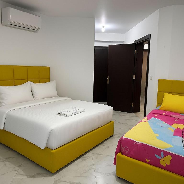 A bed or beds in a room at Porto Said Tourist Resort Luxury Hotel Apartments