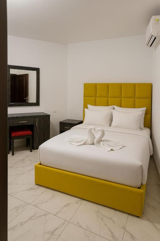 A bed or beds in a room at Porto Said Tourist Resort Luxury Hotel Apartments