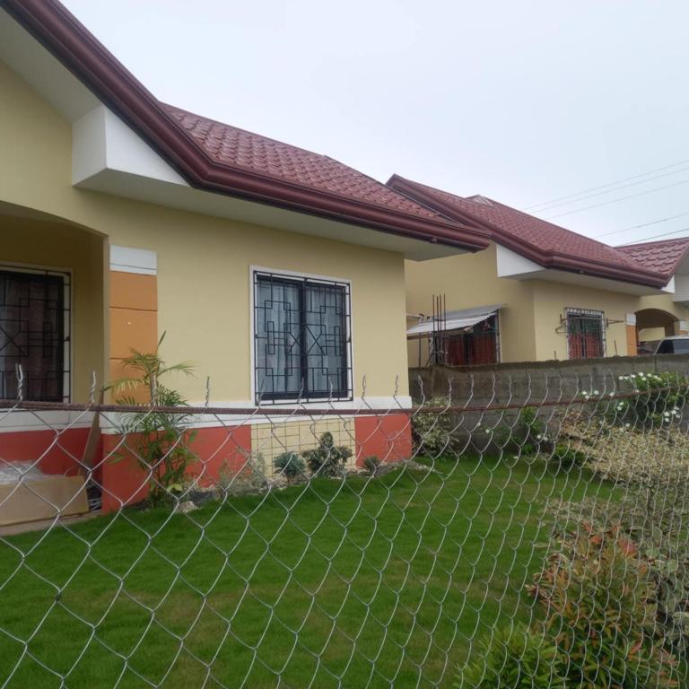 a house with a fence in front of a yard at House of DHESSA in Butuan