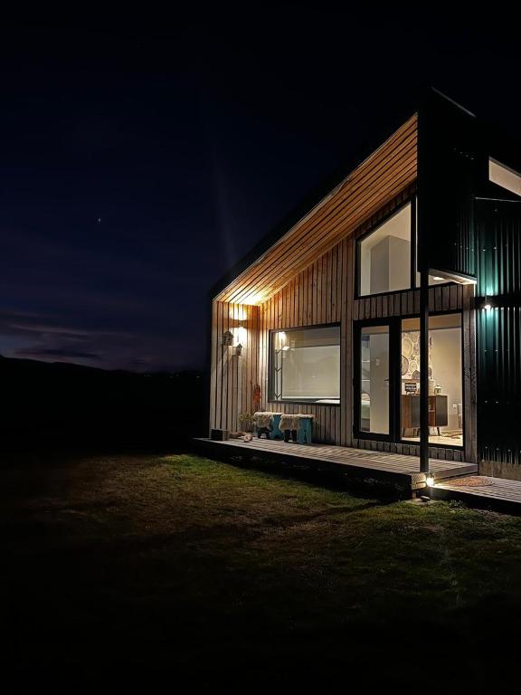 a house is lit up at night at Cabaña Julián Elias Verde in Puerto Natales