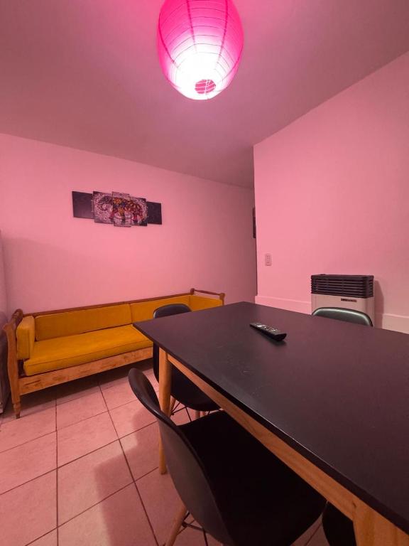 a room with a table and chairs and a couch at Alojamiento CENTRICO in Villa María