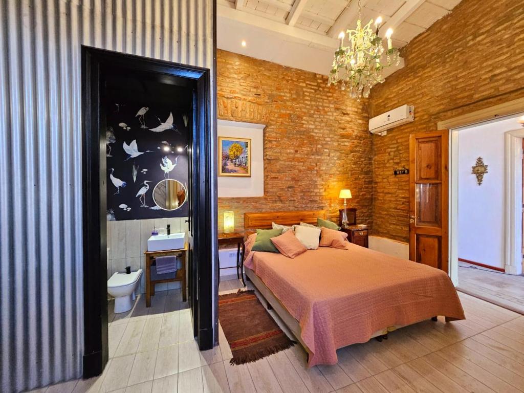a bedroom with a bed in a brick wall at El Centurión del Camino Real in Villa Tulumba