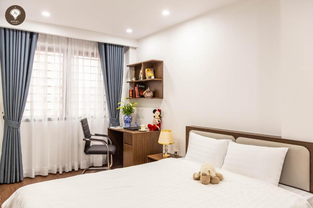 Ένα ή περισσότερα κρεβάτια σε δωμάτιο στο Opal Luxe Serviced Apartment