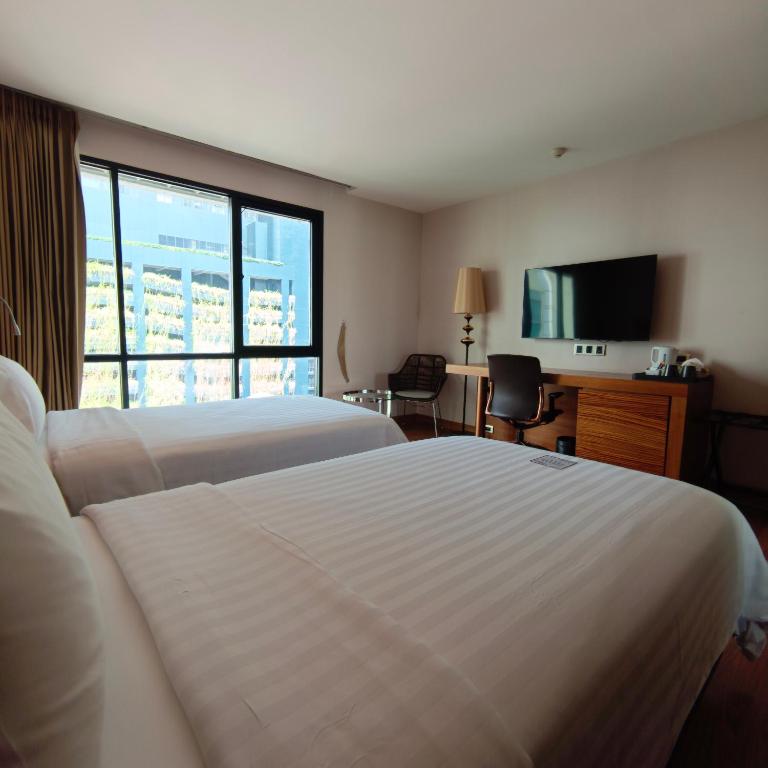 Postel nebo postele na pokoji v ubytování Sacha's Hotel Uno