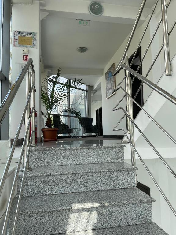 a staircase in a building with a stair railing at HOTEL Vitan273 in Bucharest