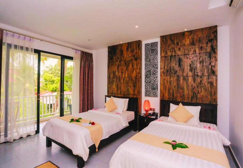 Postel nebo postele na pokoji v ubytování Angkor Home 27