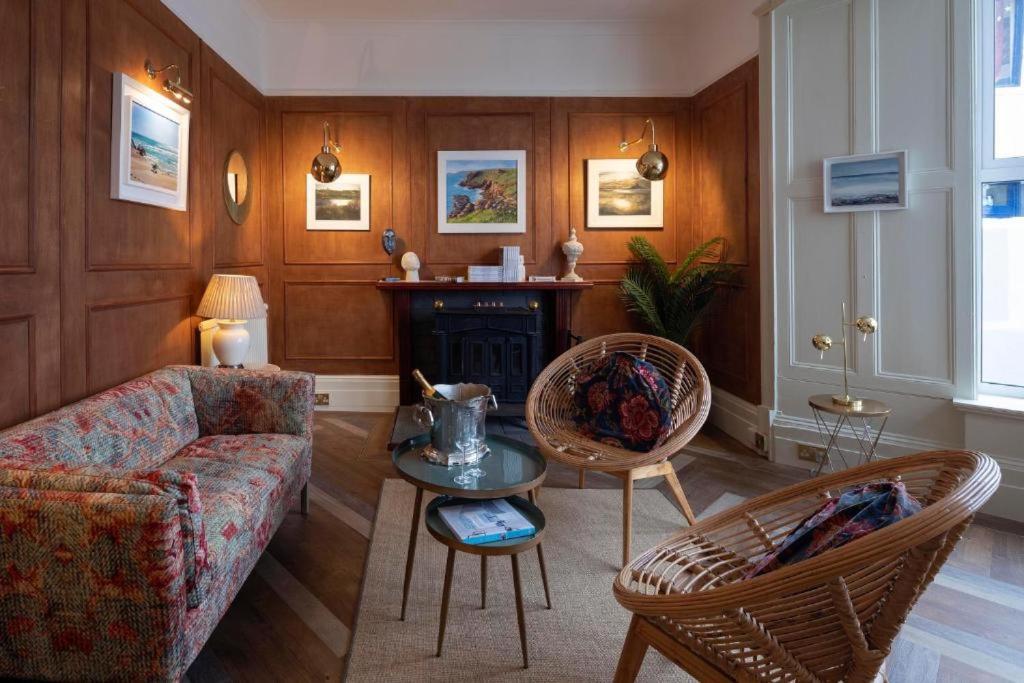 a living room with a couch and a table at Guest Lodge By The Beach Club in Penzance