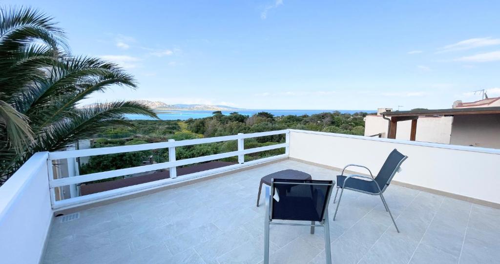 a patio with a table and chairs on a balcony at Panorama sul mare in Stintino