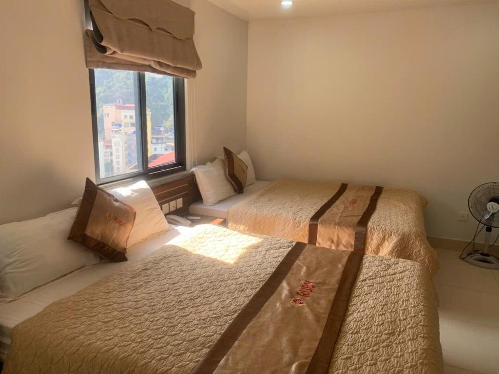 Postel nebo postele na pokoji v ubytování Ruby Hotel
