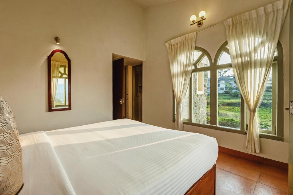 Postel nebo postele na pokoji v ubytování Mango Hill Shola Ooty
