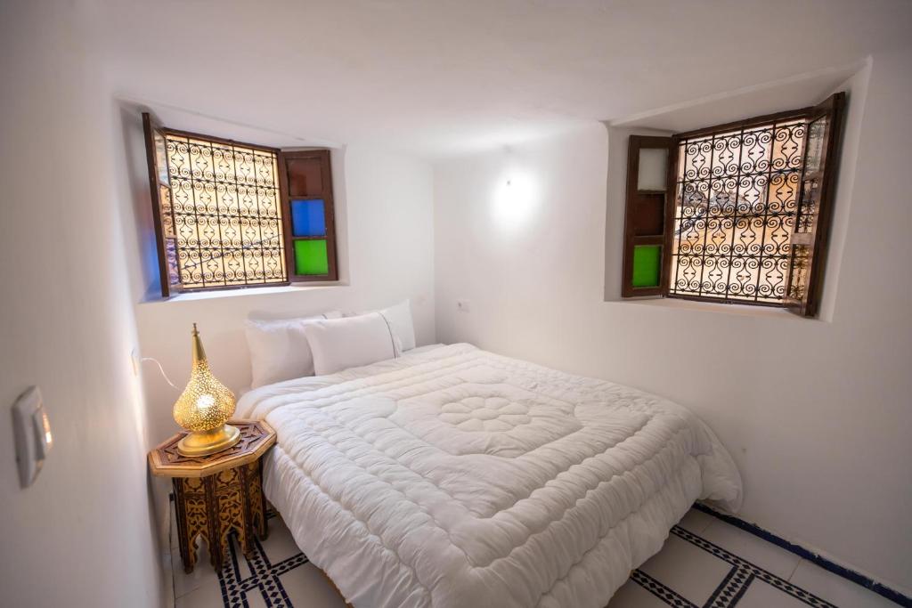 Postel nebo postele na pokoji v ubytování Riad Old City Palace