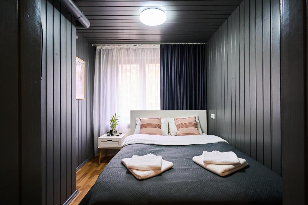 a bedroom with a bed with two towels on it at Studio Near Airport WiFi Valea Crucii 6 in Chişinău