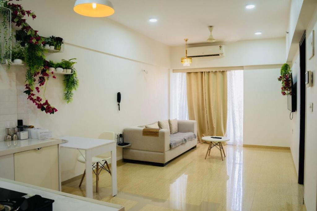 a living room with a couch and a table at Le Plaisir at Lodha Belmondo 2 mins walk to Golf in Dehu Road