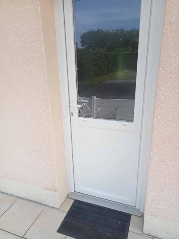 d'une porte blanche avec vue sur la cour. dans l'établissement Chambre d hôte, à La Celle-sous-Gouzon