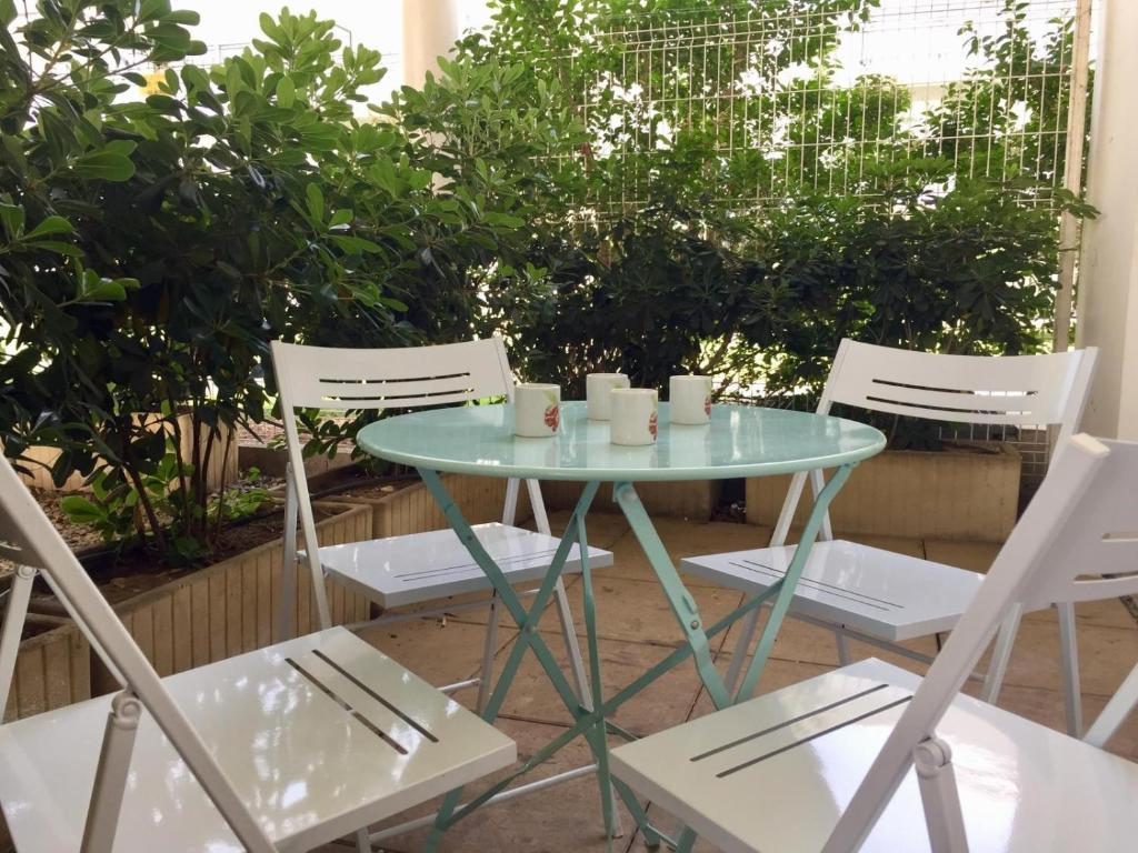 a table and chairs with cups and candles on it at Appartement 2 pièces La Rochelle - LR030-B11 in La Rochelle